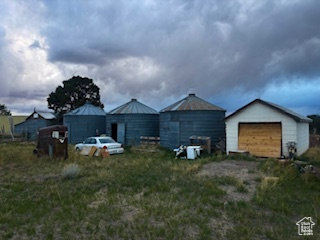 View of yard featuring a garage and an outdoor structure