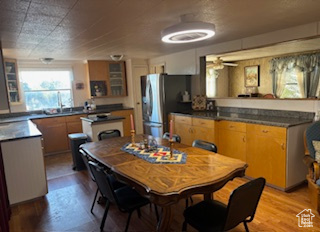 Dining room featuring wood finished floors and ceiling fan