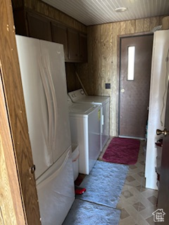Laundry room featuring independent washer and dryer, cabinet space, and wooden ceiling