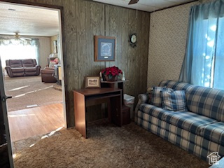 Living room with ceiling fan and carpet