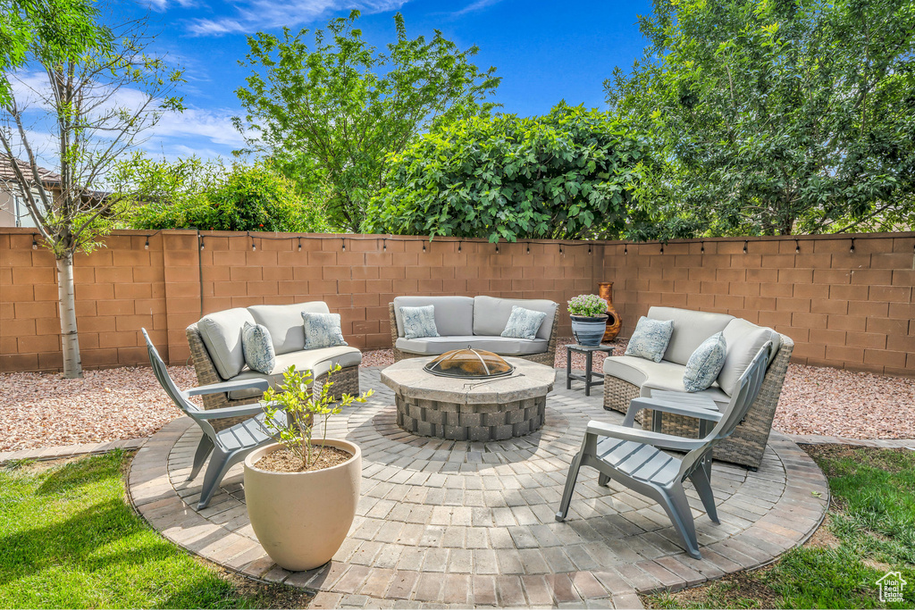 View of patio with an outdoor living space with a fire pit and a fenced backyard