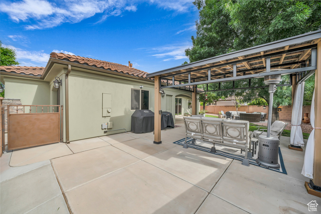 View of patio / terrace with an outdoor hangout area, grilling area, and a gazebo