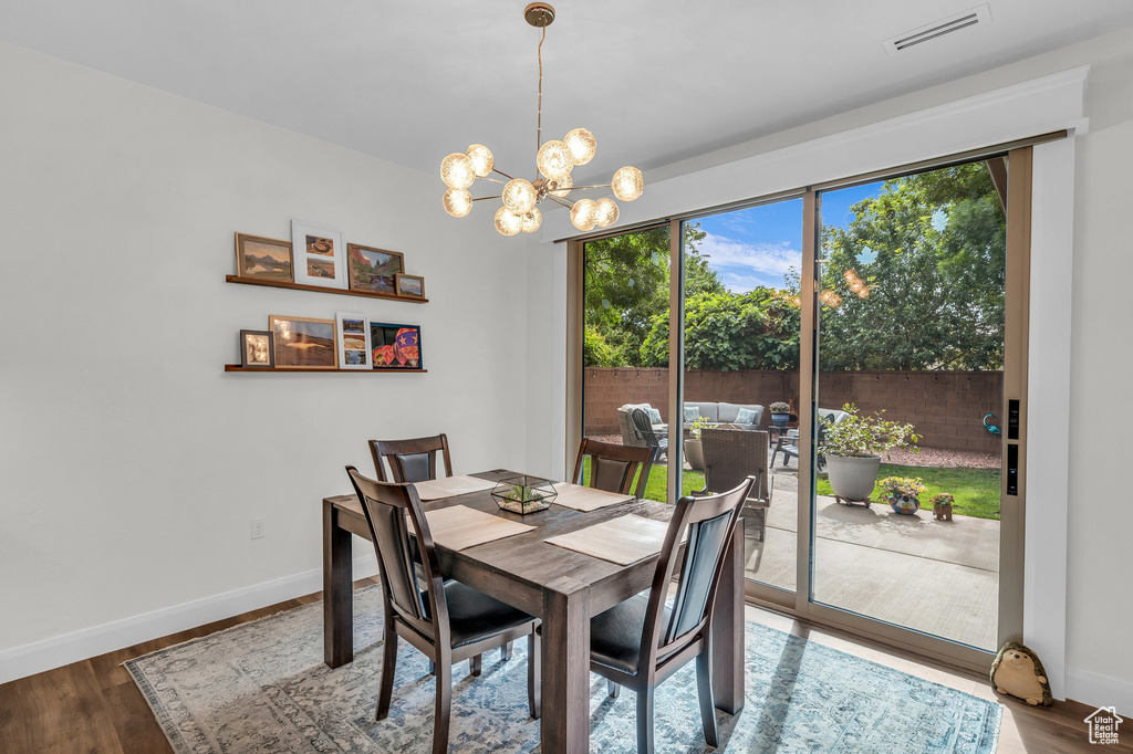 Dining room with a chandelier and wood finished floors