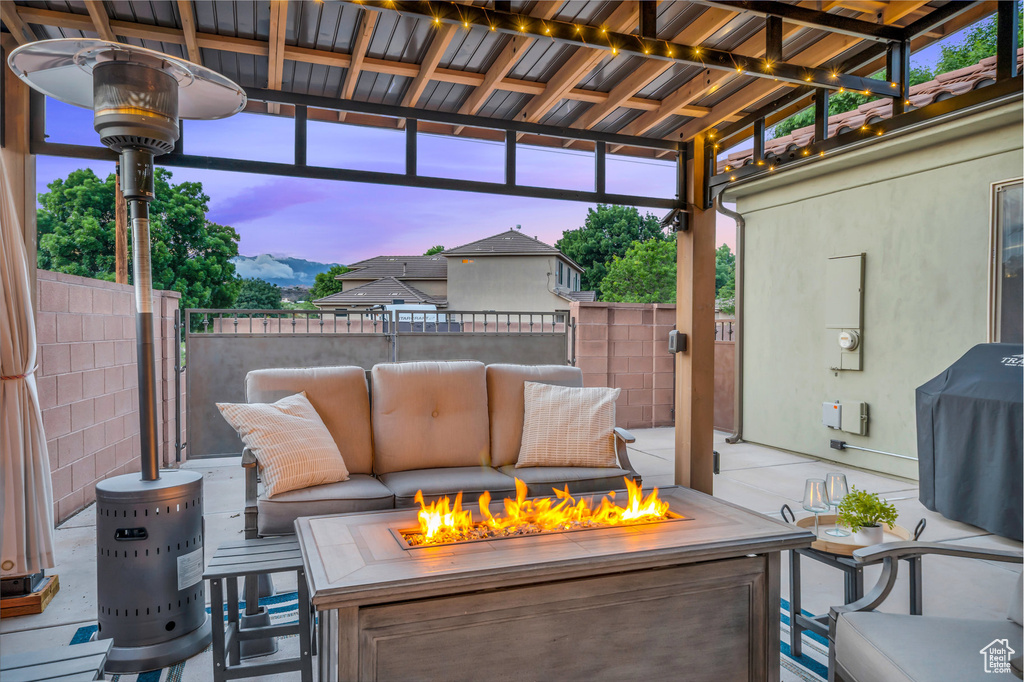 View of patio / terrace with a fire pit, fence, and area for grilling