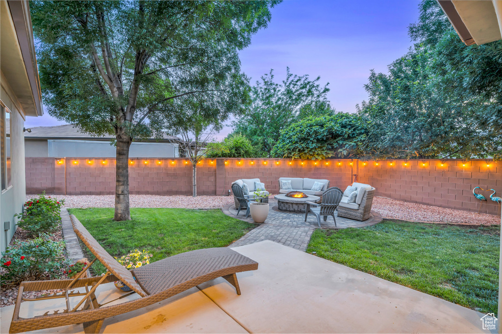 Patio terrace at dusk featuring an outdoor living space with a fire pit