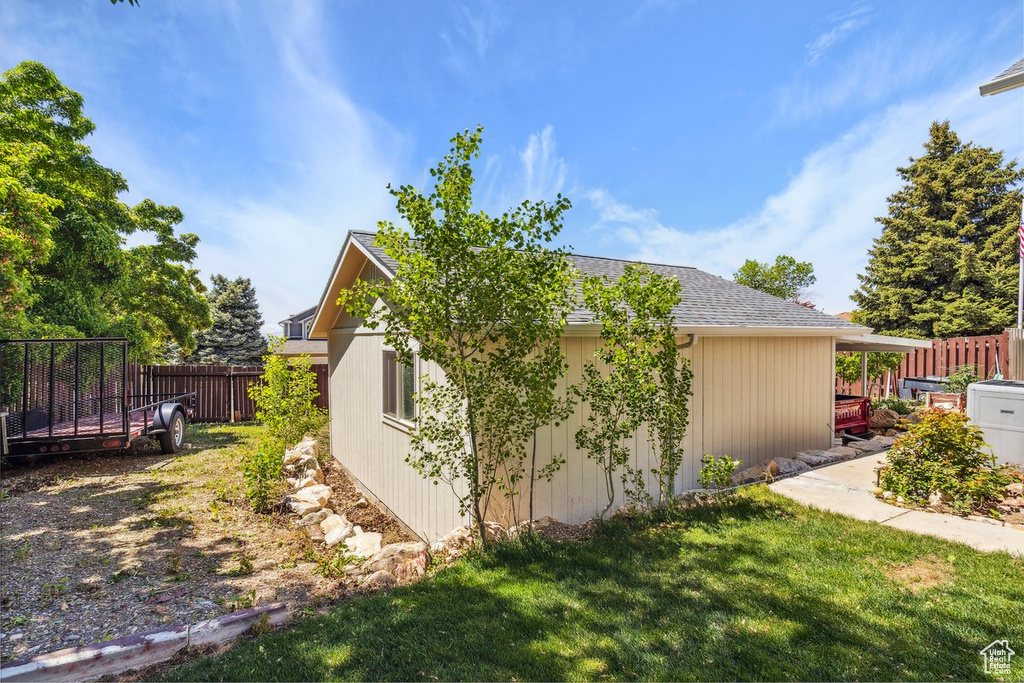 View of property exterior featuring a shingled roof
