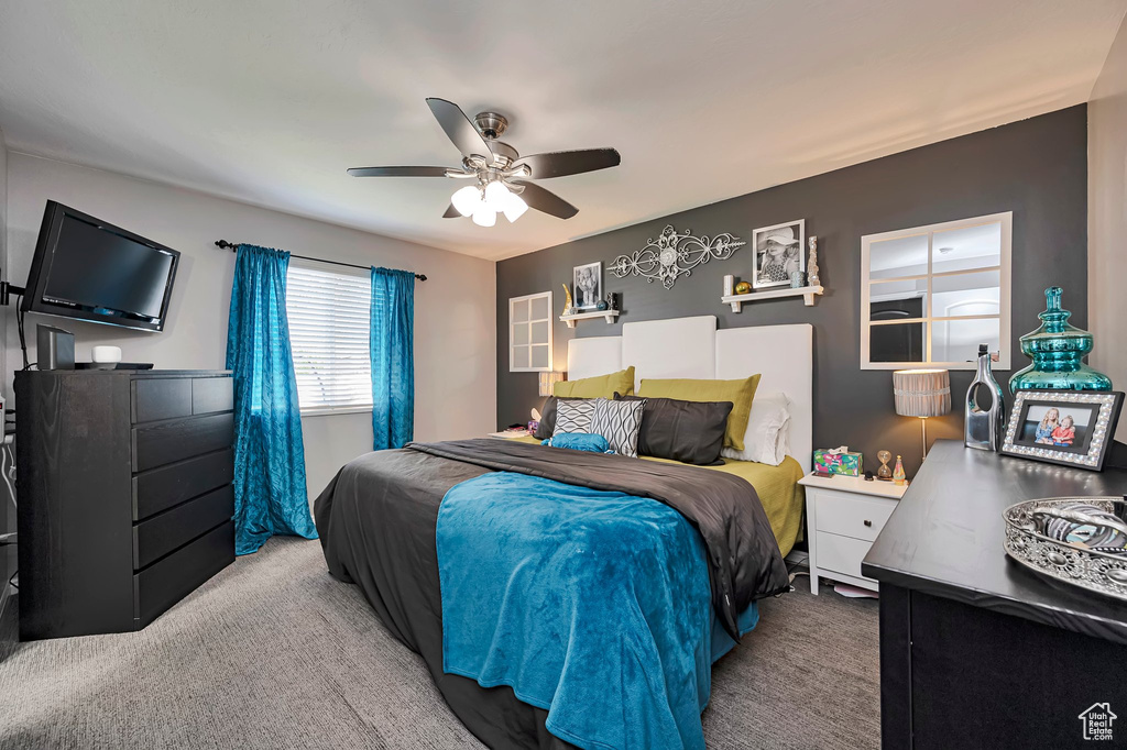 Carpeted bedroom with ceiling fan