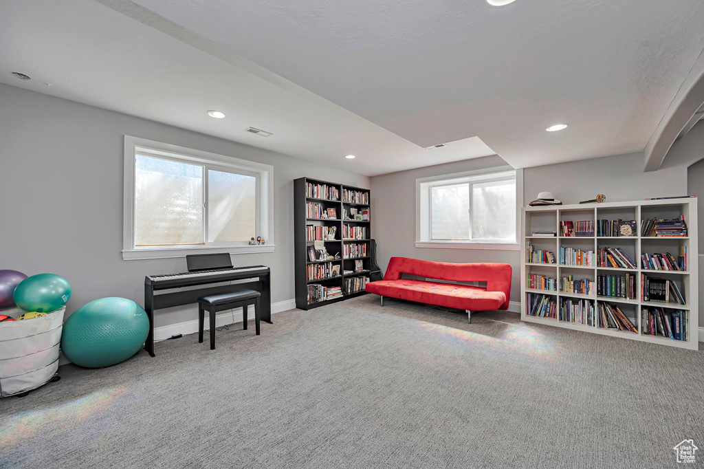 Living area with carpet floors, baseboards, and recessed lighting