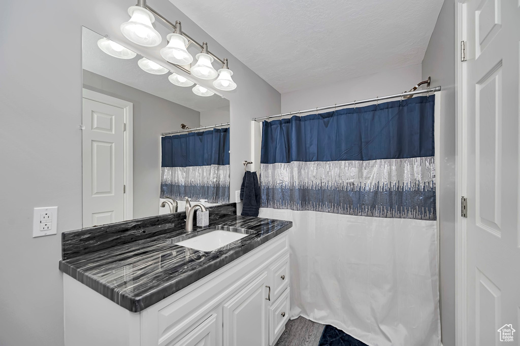 Full bathroom with vanity and curtained shower