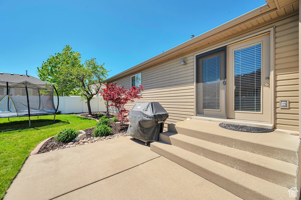 View of patio featuring a grill and a trampoline