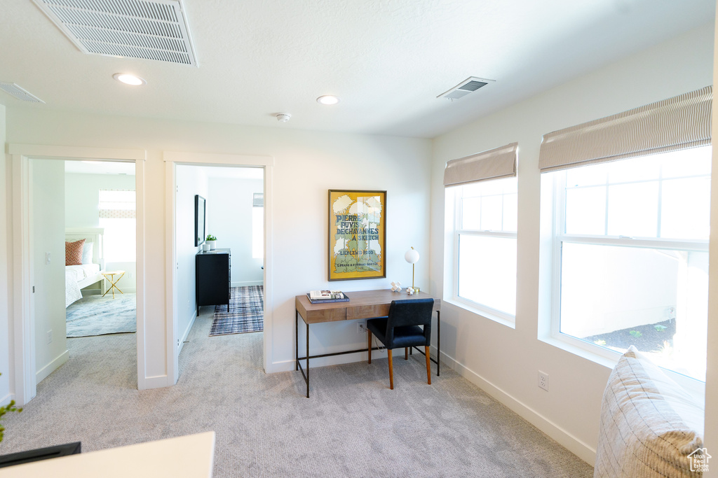 Carpeted office space featuring baseboards and recessed lighting