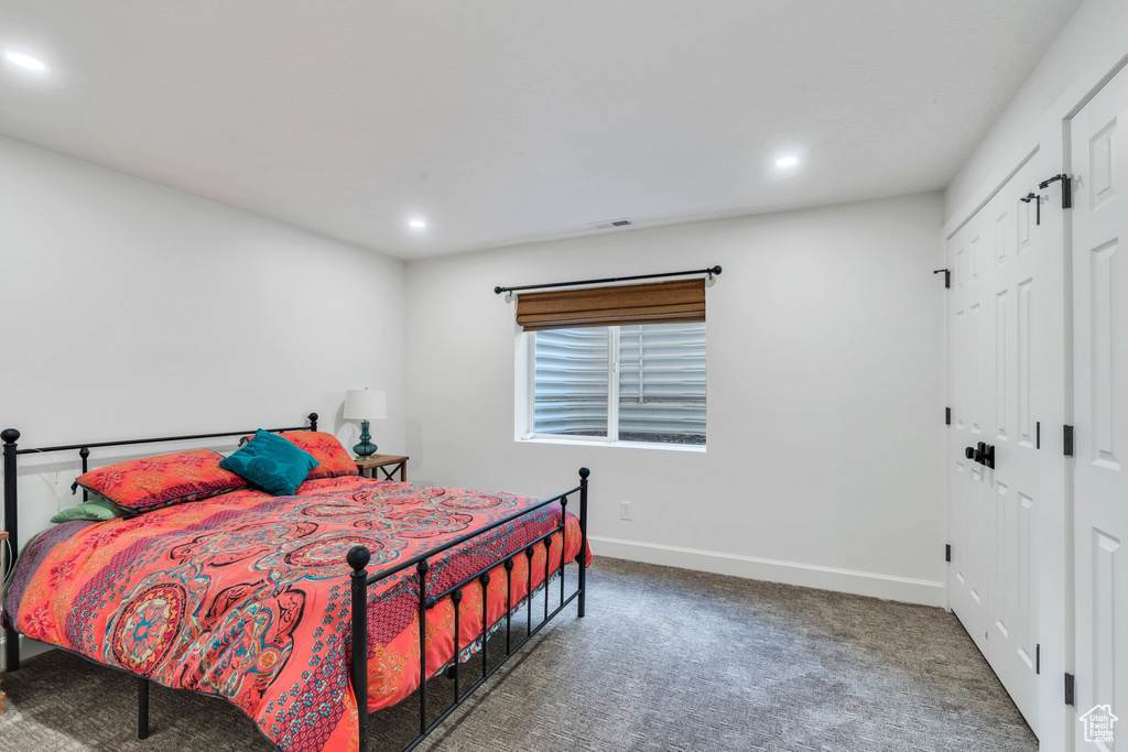 Carpeted bedroom featuring baseboards and recessed lighting