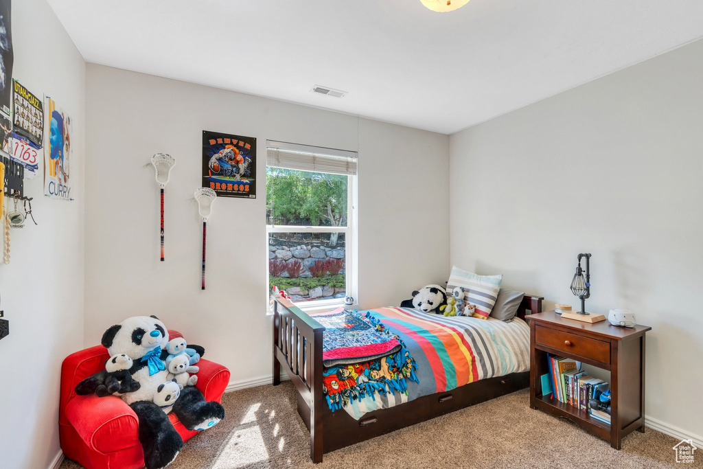 Carpeted bedroom featuring baseboards