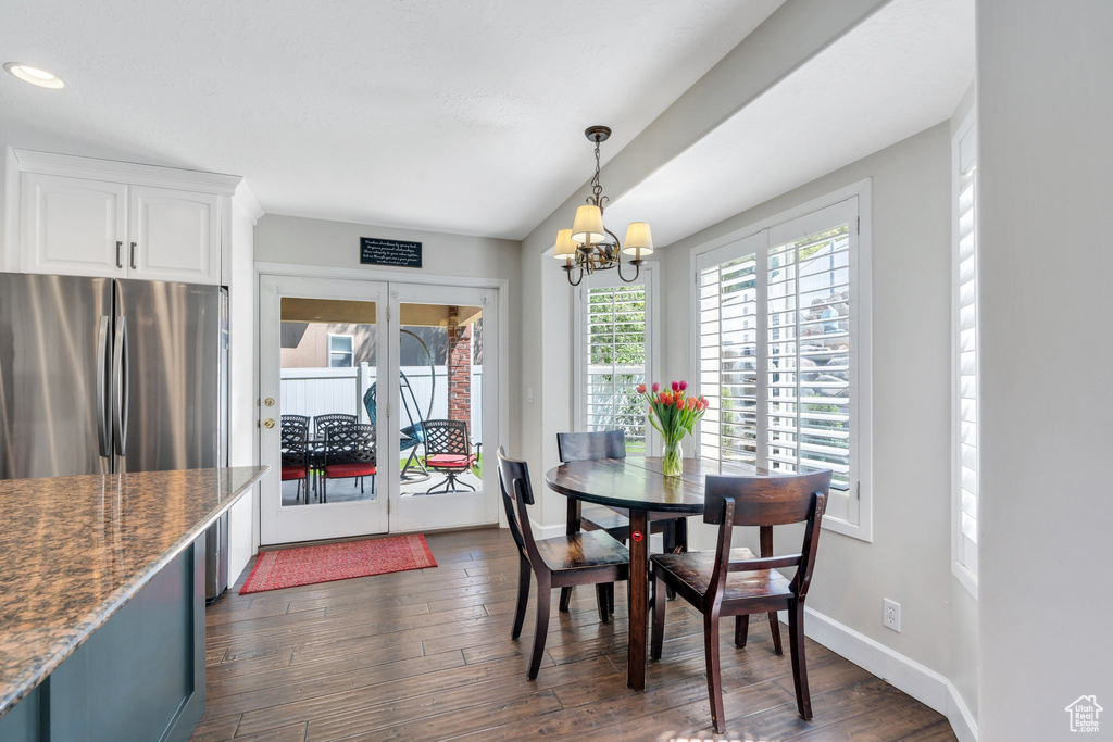Dining room featuring french doors, dark wood-type flooring, a chandelier, baseboards, and recessed lighting