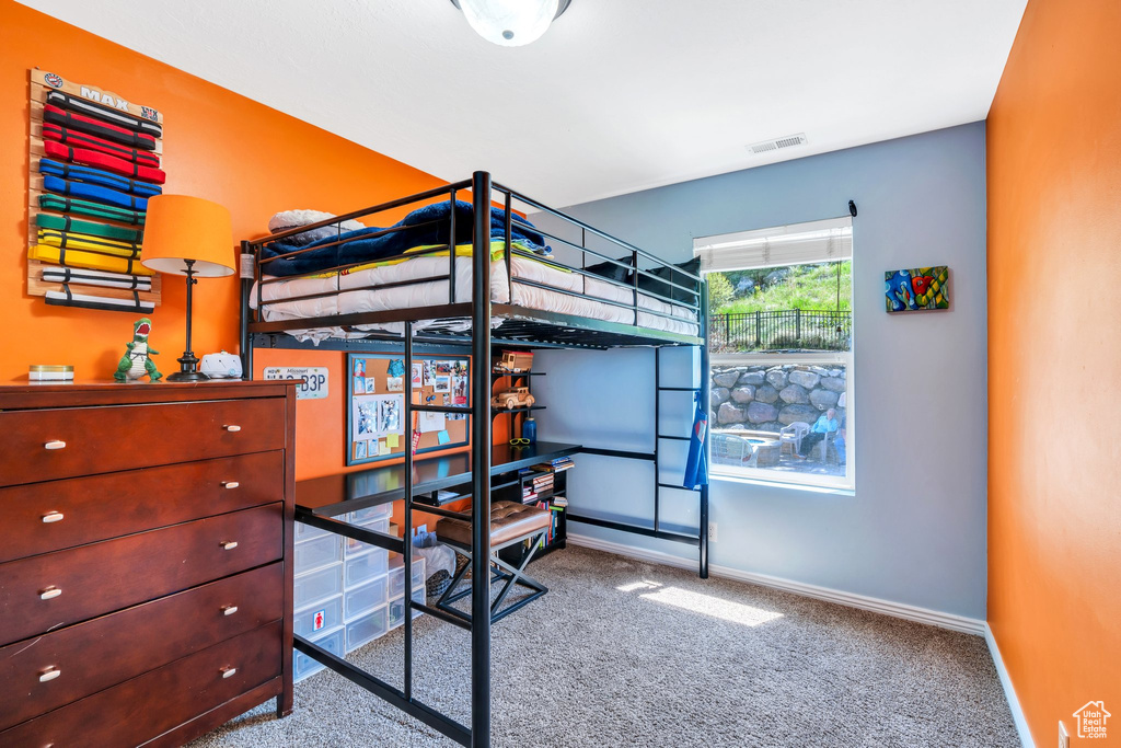 Bedroom featuring carpet floors and baseboards