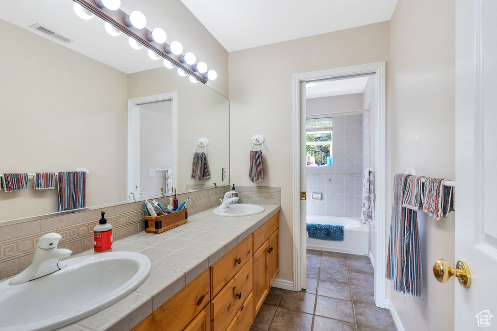 Bathroom featuring double vanity and tile patterned flooring