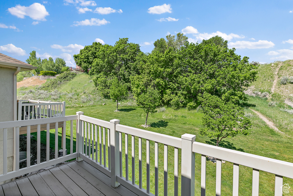 Wooden terrace featuring a lawn