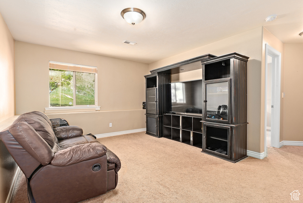 Living area with carpet and baseboards