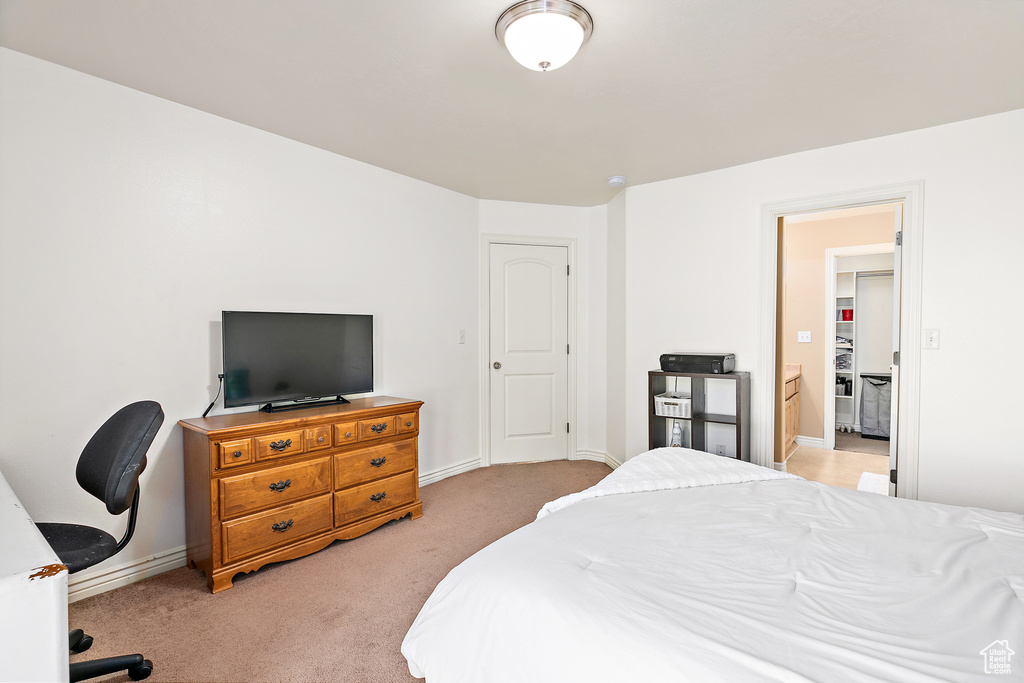 Bedroom featuring light colored carpet and baseboards