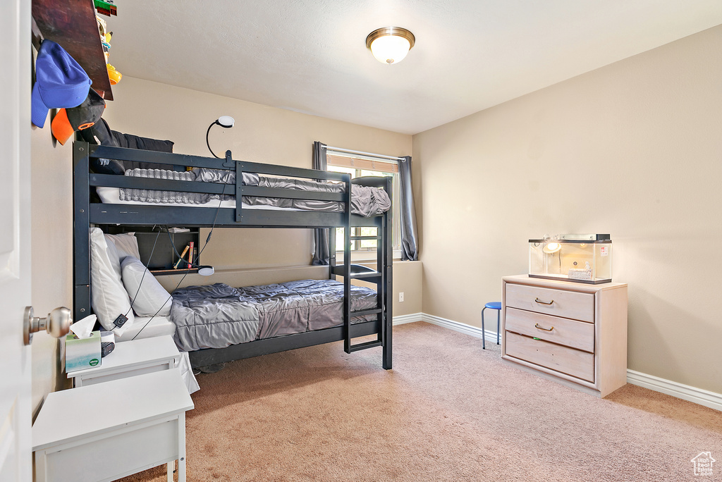Carpeted bedroom featuring baseboards