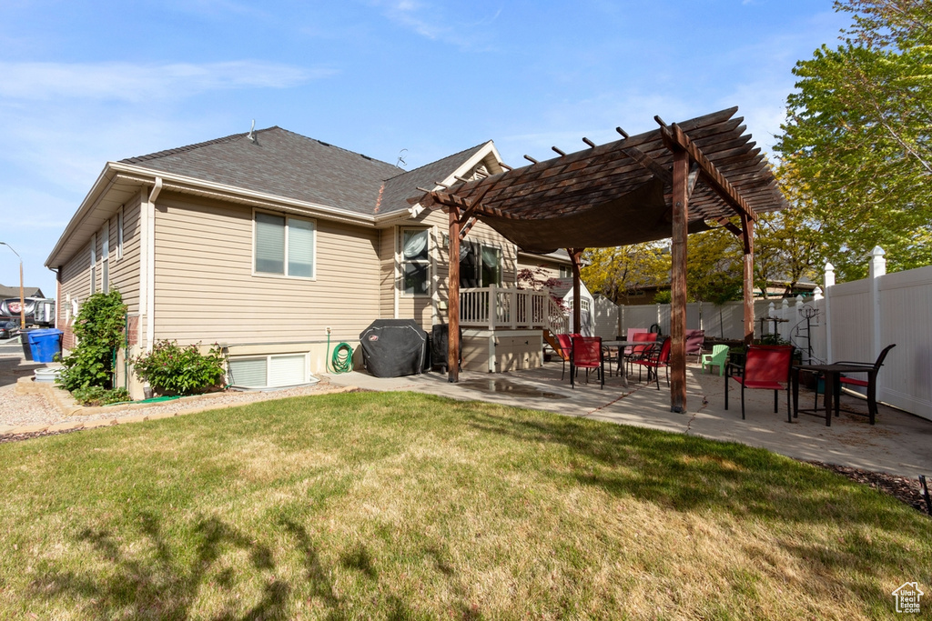 Back of property featuring a pergola, a patio, and roof with shingles