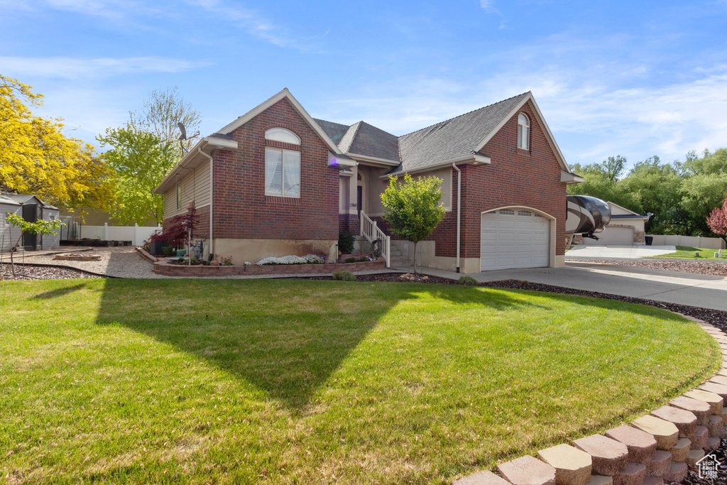View of front facade featuring brick siding, a garage, concrete driveway, and roof with shingles