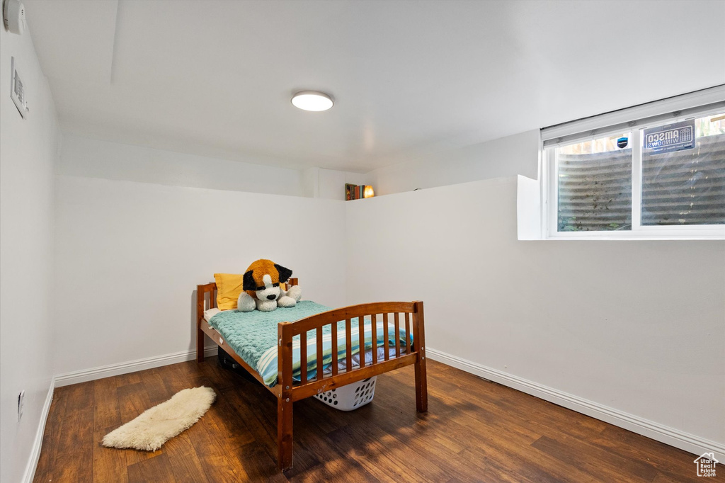 Bedroom featuring baseboards and wood finished floors