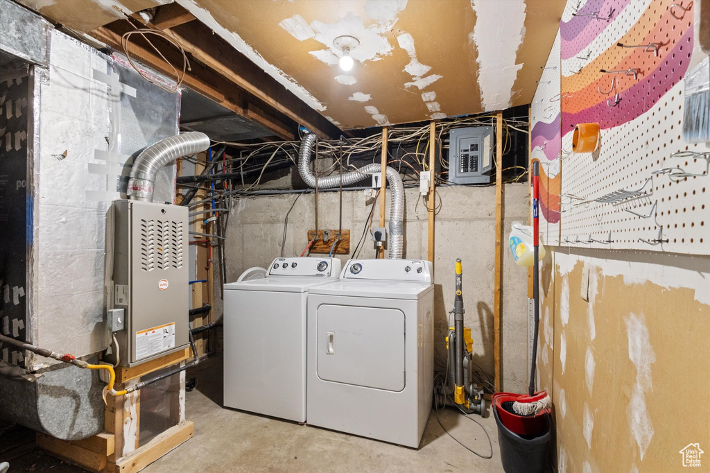 Washroom with washer and dryer, laundry area, and electric panel