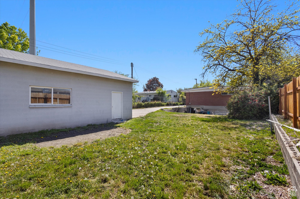 View of yard featuring fence