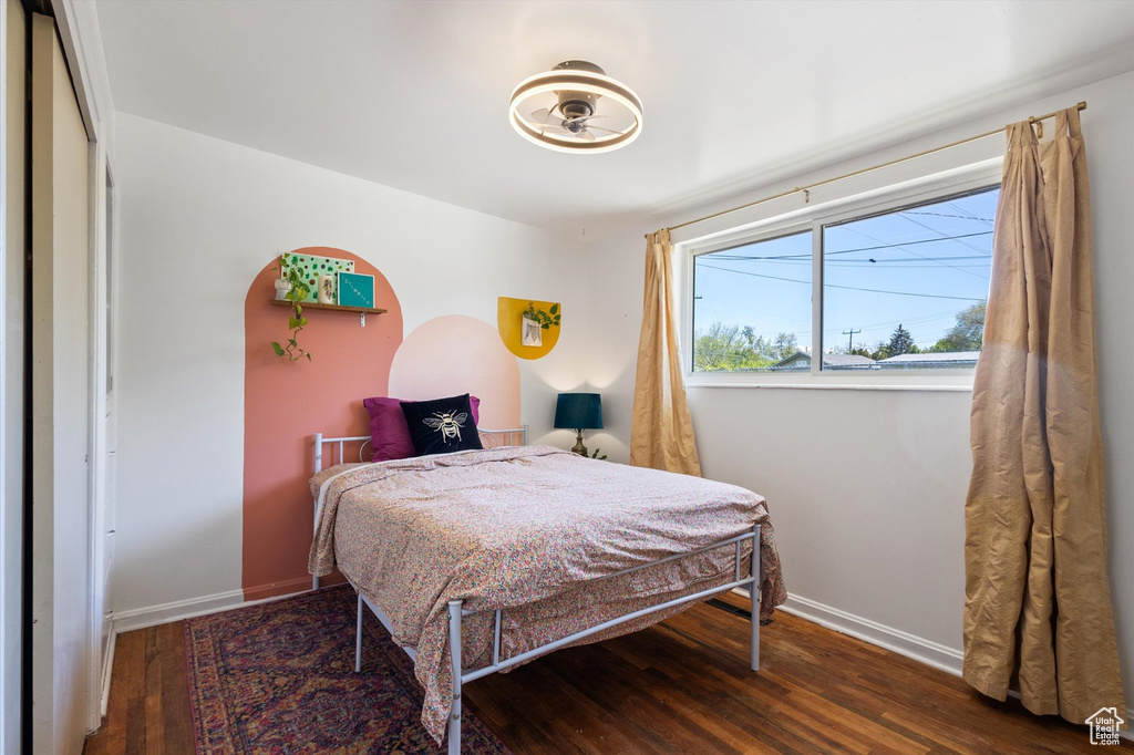 Bedroom with baseboards and hardwood / wood-style flooring