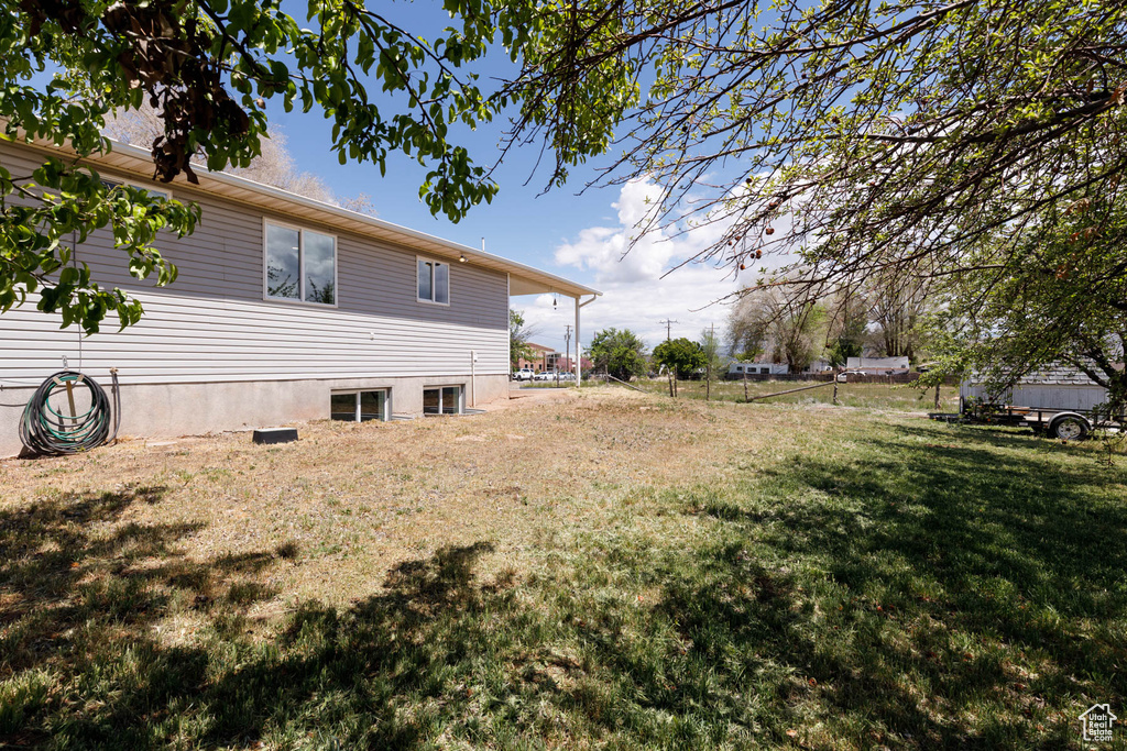 View of property exterior with a lawn