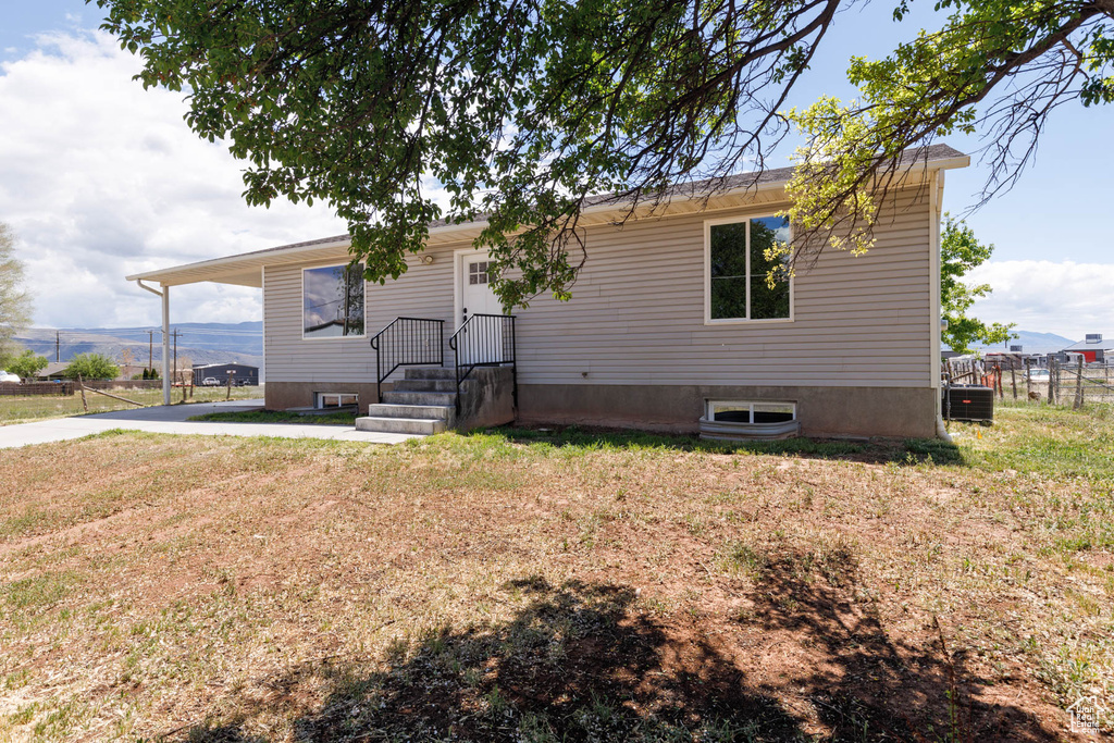 View of front of property featuring central air condition unit and a mountain view
