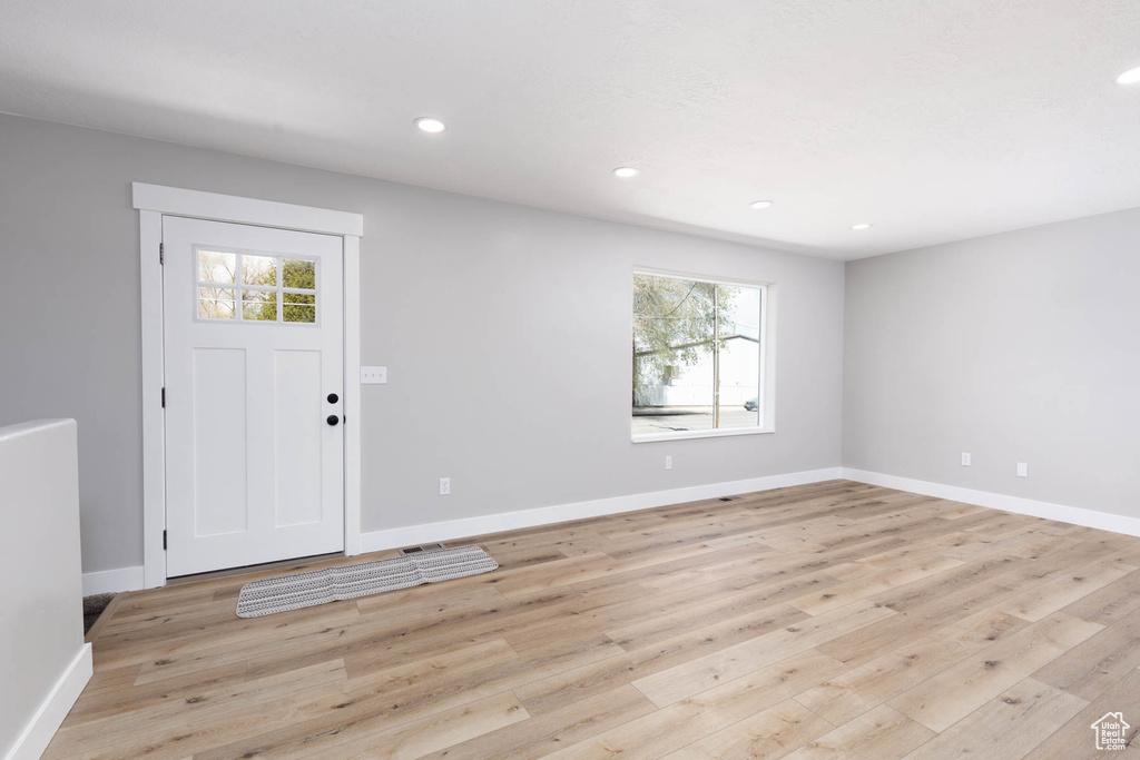 Entrance foyer with light wood-style flooring, recessed lighting, and baseboards