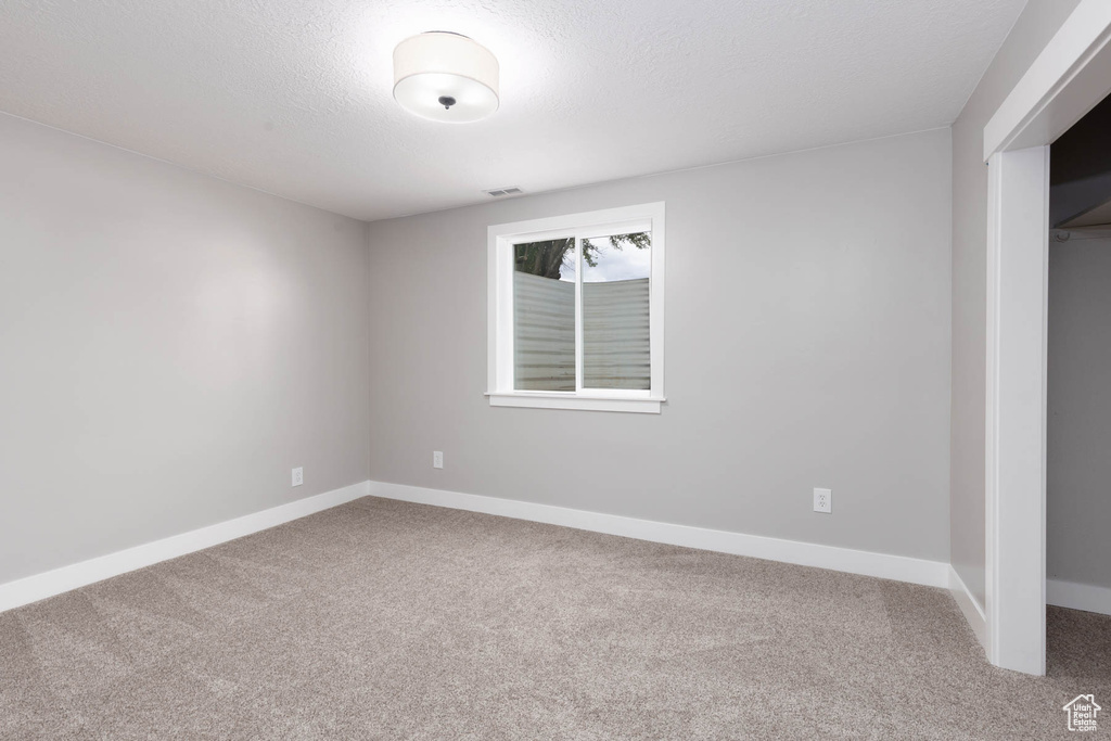 Unfurnished bedroom featuring carpet floors, baseboards, and a closet