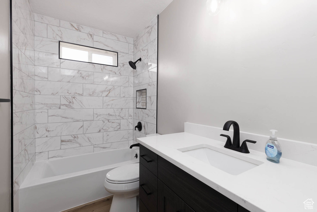 Full bathroom with vanity, toilet, and shower / bath combination
