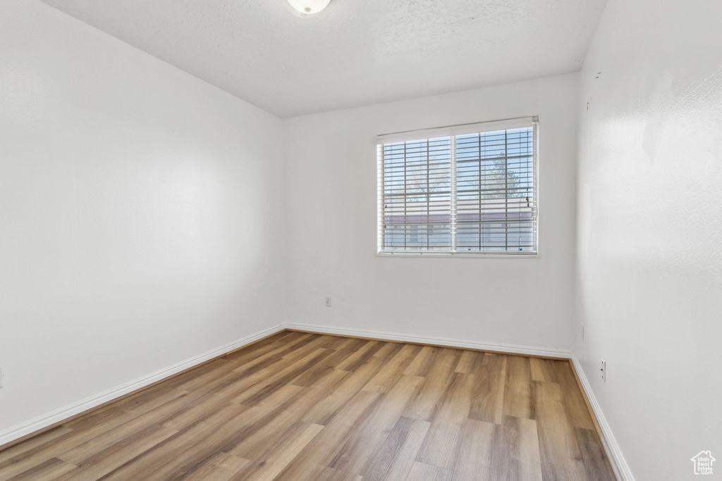 Unfurnished room featuring light wood-type flooring and baseboards