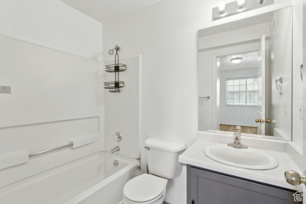 Bathroom with vanity, toilet, and shower / bathtub combination