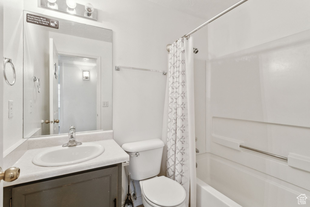 Full bathroom with vanity, toilet, and shower / bath combo