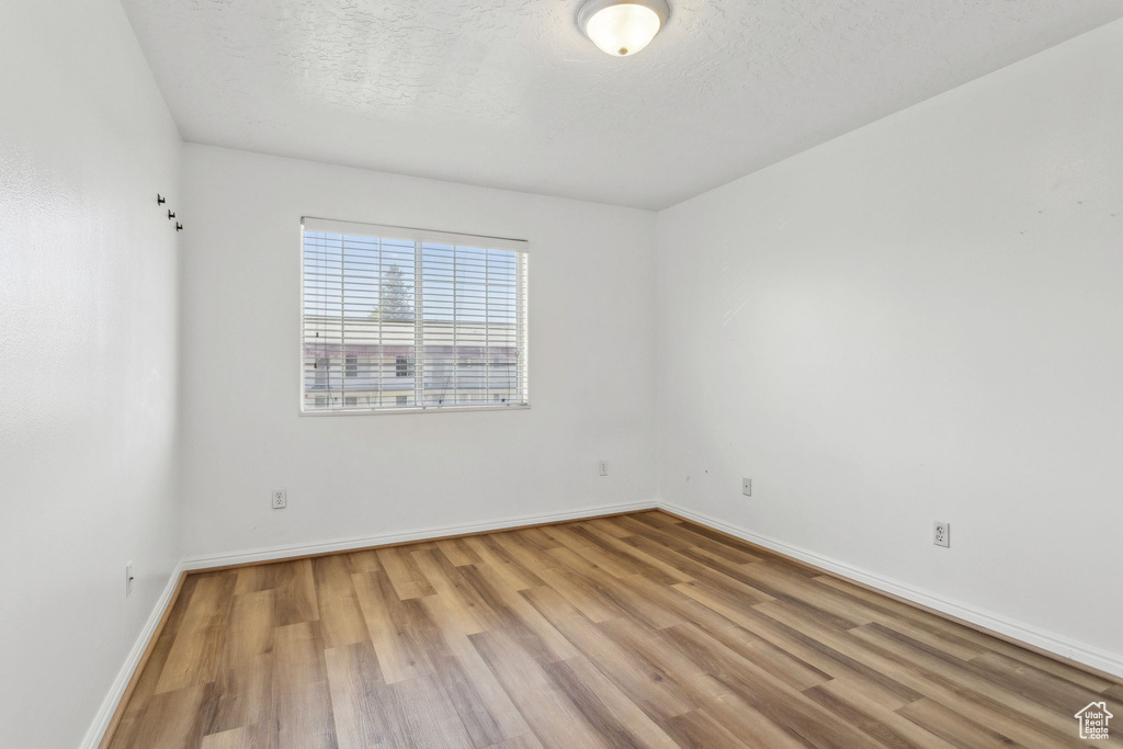 Empty room featuring light wood-type flooring and baseboards