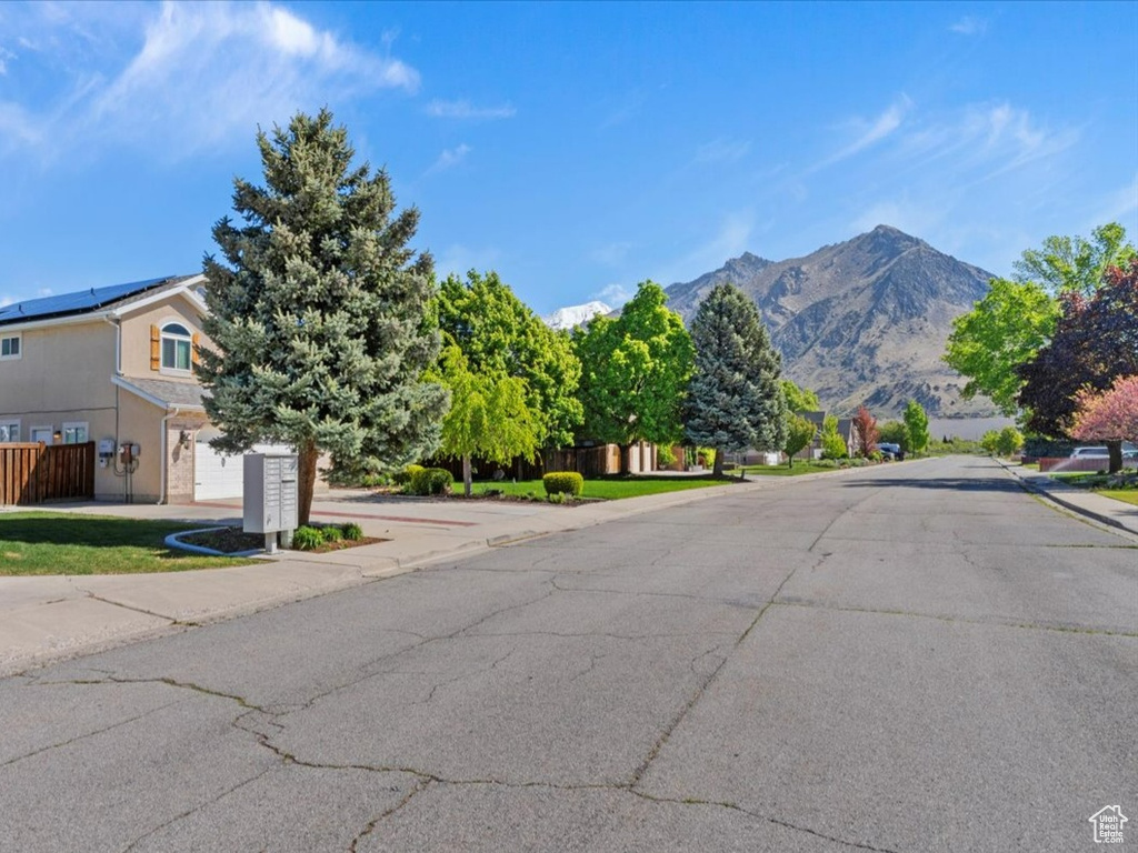 View of asphalt road with a mountain view and sidewalks