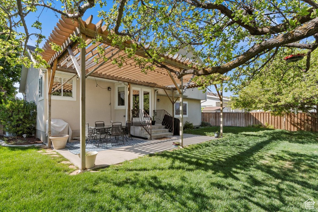 Back of property featuring a pergola, stucco siding, and a patio