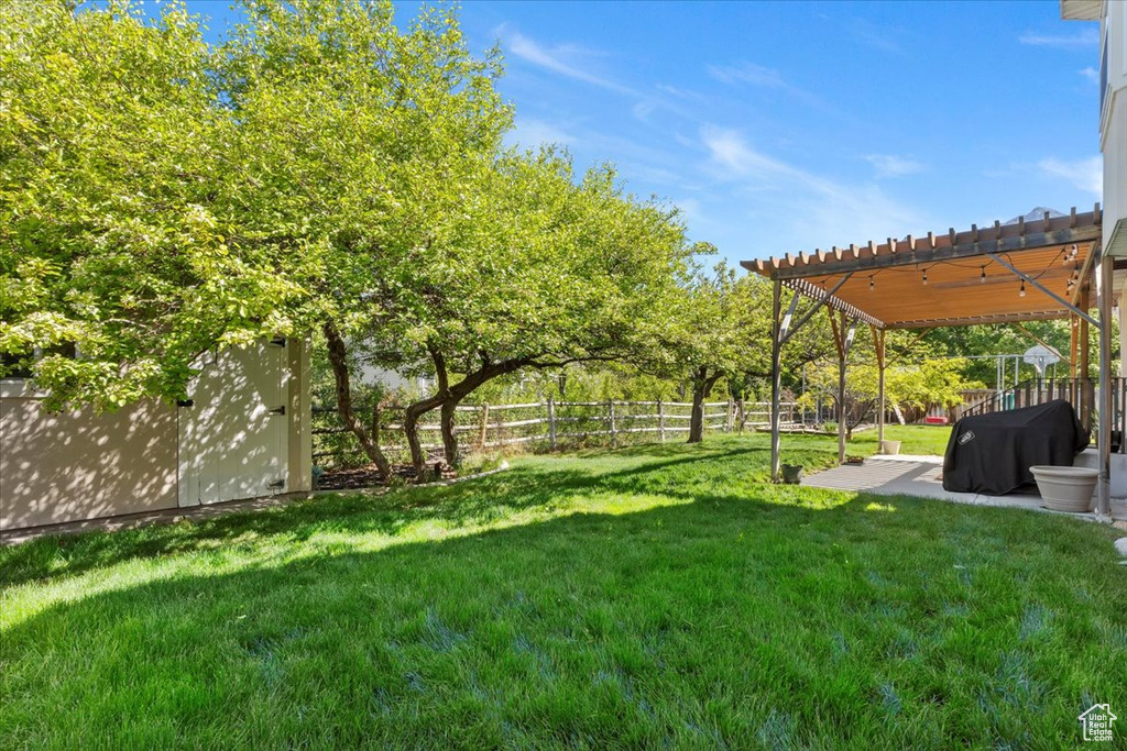 View of yard featuring a pergola and a patio