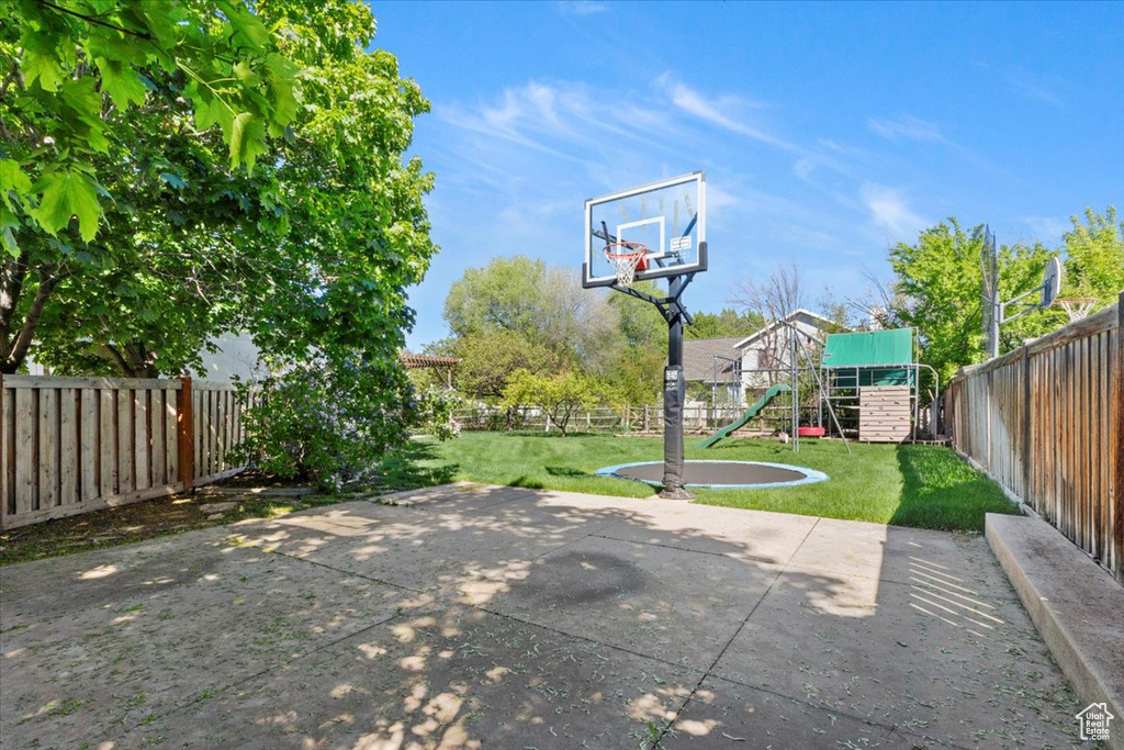 View of basketball court featuring a playground
