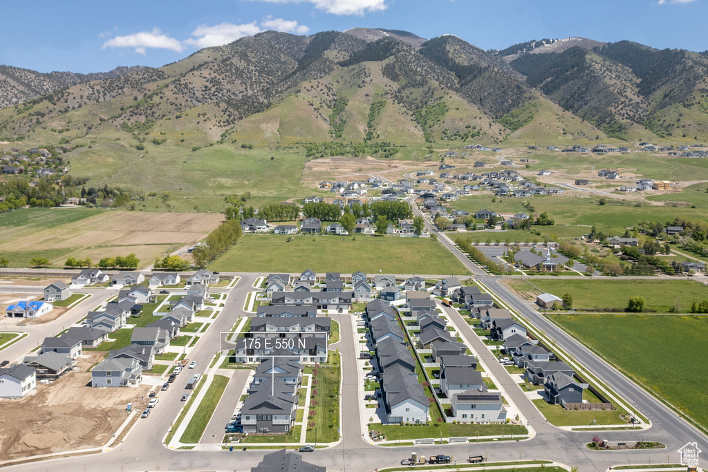 Aerial view of property's location featuring mountains and nearby suburban area