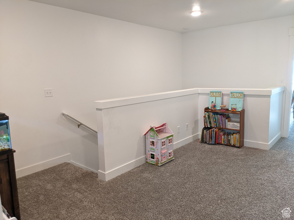 Playroom with baseboards and carpet