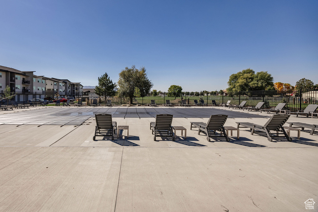 View of patio with fence and a residential view