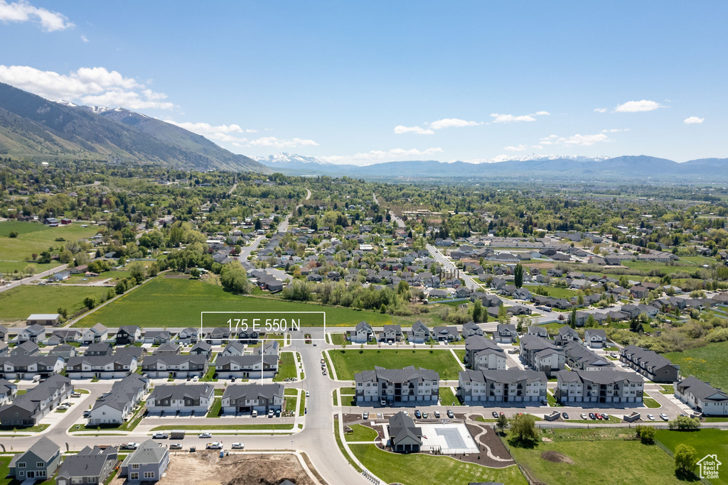 Aerial perspective of suburban area with a mountainous background
