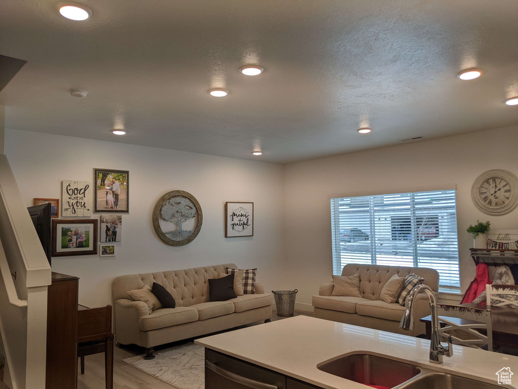 Living room featuring light wood-style floors and recessed lighting