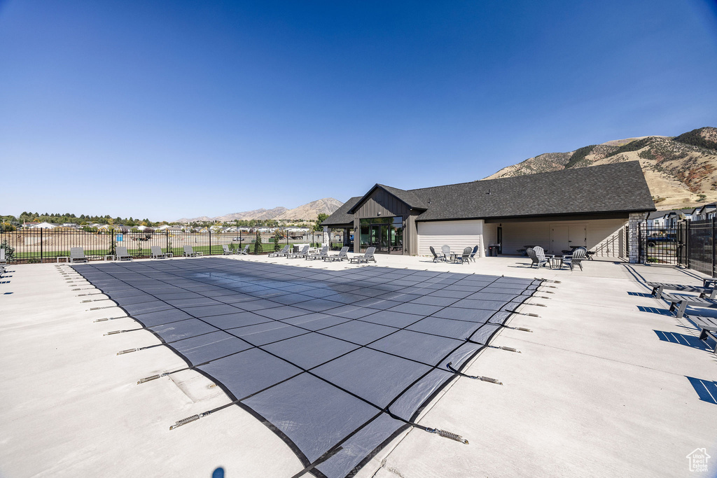 View of pool with a mountain view, fence, and a patio
