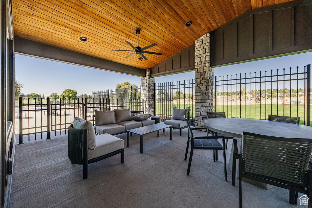 View of patio / terrace with an outdoor hangout area, outdoor dining area, ceiling fan, and fence